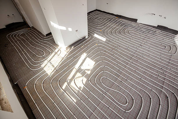 istock Pipe system of floor heating mounted in residential building under construction 2242345544
