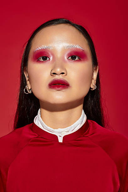 istock Vibrant beauty with striking eye makeup in a bold red studio setting 2242352653