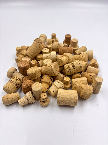 Macro image showing a pile of different cork stoppers with visible natural texture and variety.