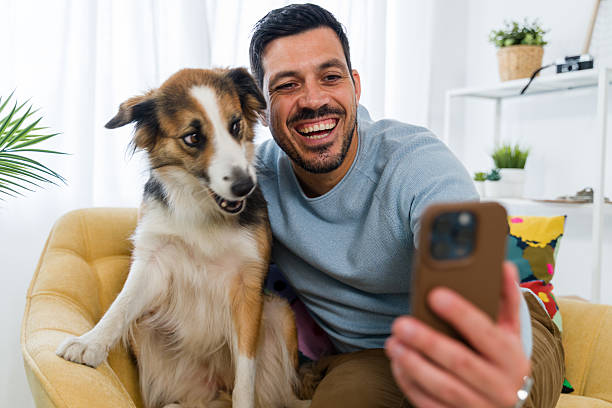 istock Man and dog taking selfie with smartphone 2242354762