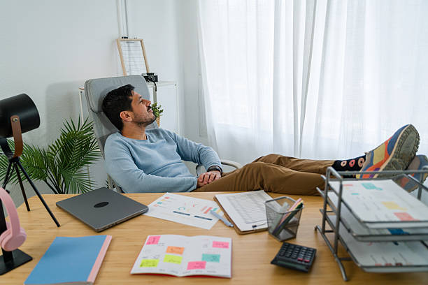 istock Man relaxing at home office desk contemplating future ideas 2242354855