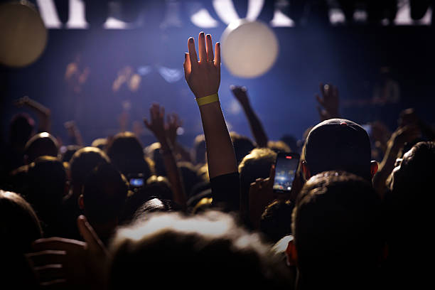 istock Raised hand in music crowd during live concert 2242354863