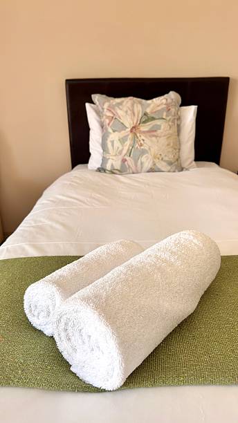 A single bed in a hotel room awaits guests