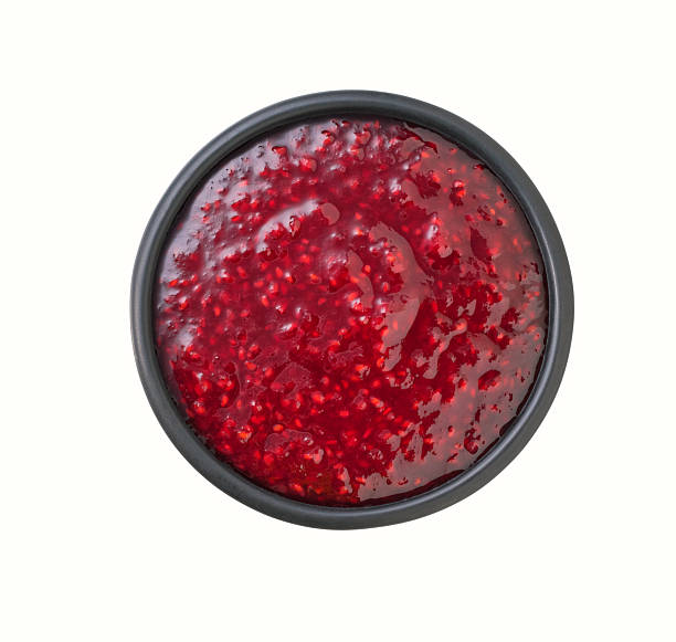 istock raspberry jam in a black bowl isolated on white background, top view. 2242355869