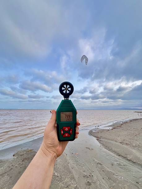 istock Hand holding a digital anemometer showing wind speed and temperature by the seaside 2242356487