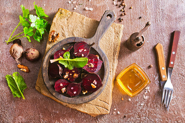 Vegetarian salad from boiled beet on wooden board