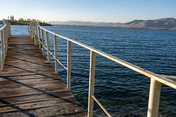 Rustic Wooden Dock on the Calm Lake with Mountainous Background