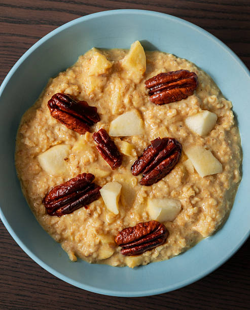 istock creamy pumpkin oatmeal topped with fresh apple slices and caramelized pecans 2242360890