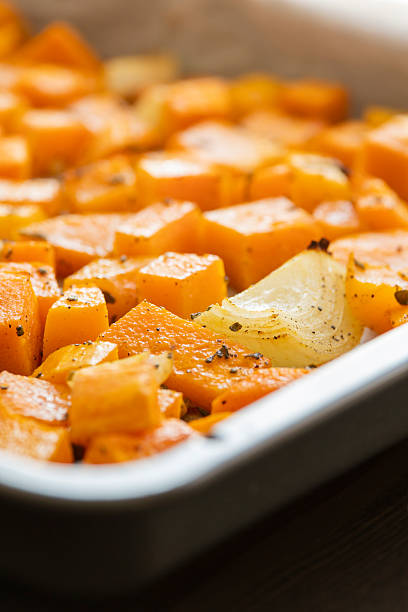 istock tray with roasted pumpkin butternut squash onion and garlic close up 2242360943