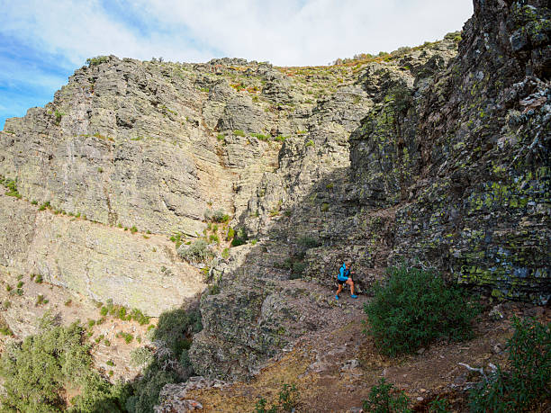 istock Mountain athlete among cliffs overcoming the difficulties of the path 2242361562