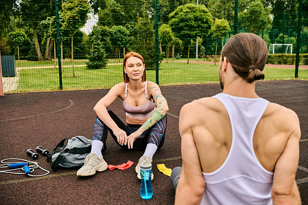 istock Outdoor workout session between young athlete and her personal trainer in a vibrant park 2242364519