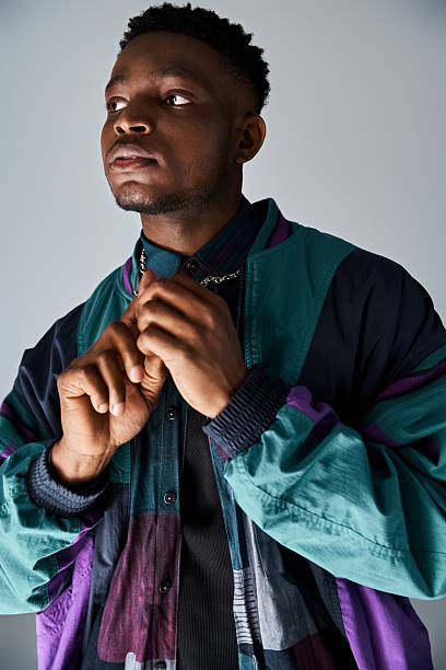 istock Stylish young man poses confidently in trendy attire against a plain background 2242367132