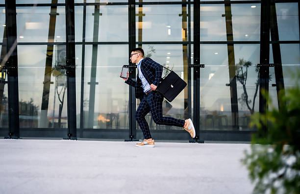 istock Businessman running with tablet and briefcase, hurry to work 2242367478
