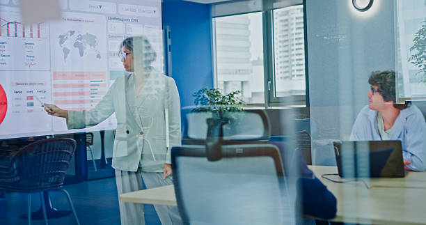 istock Diverse business team presents company data and performance charts meeting discussing strategy planning investment marketing strategies in modern office. Sustainable business and finance concept. 2242367688