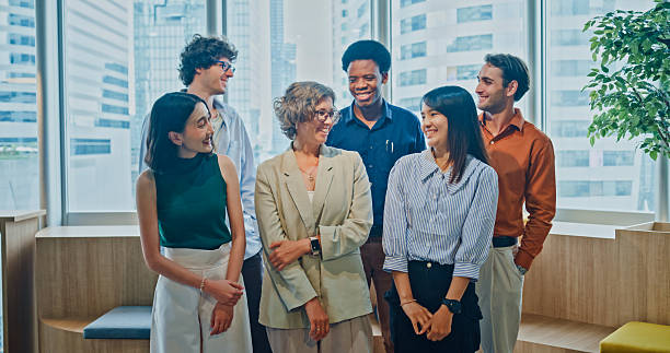 istock Diverse business team smiling looking at camera, representing teamwork, leadership, and success in modern office. Sustainable business and finance concept. 2242367756