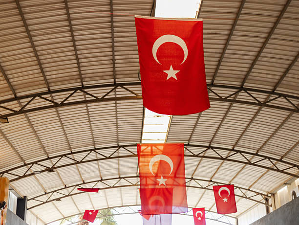 istock Red Turkish flags are suspended from the ceiling in a large indoor space, creating a vibrant and festive atmosphere during a cultural event in Turkey 2242368401