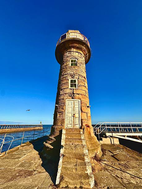 istock An old lighthouse at Whitby against blue sky 2242371946