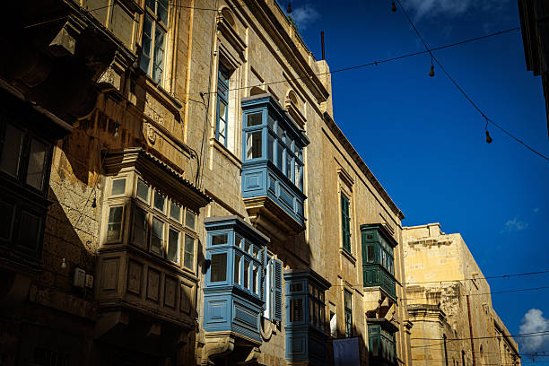 Classic Maltese buildings with blue wooden balconies and bright sky. Great for illustrating southern European architecture, Mediterranean culture, or tourism.
