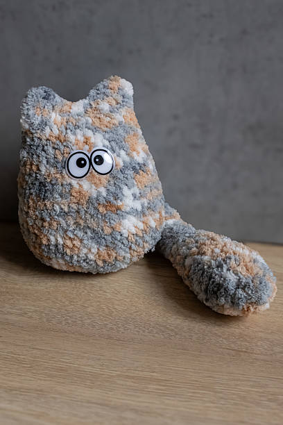 istock Cute soft bright cat with funny eyes, crocheted in the amigurumi technique 2242372337