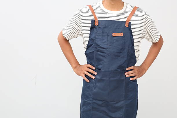 istock Crop anonymous male worker in apron standing with hands on waist. Isolated on white 2242372927