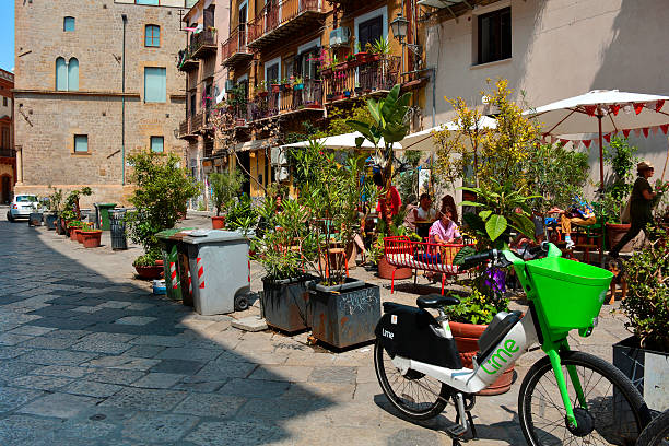 Palermo, Italy - May 18 2025. Piazza Aragona, known as Artists' Square, in the Kalsa quarter of Palermo. A charming square in the vibrant historic centre, its architecture is a blend of historical styles, particularly Baroque - ornate balconies with wrought-iron railings, decorative window surrounds & cornices. Paved with traditional stone, with benches & plants, creating an inviting & lively urban space with an authentic atmosphere