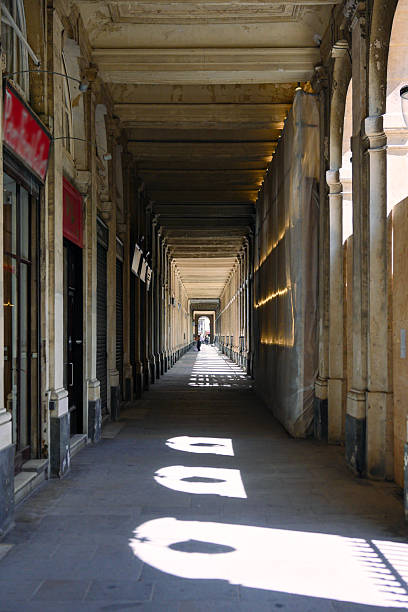 istock Historic colonnade with sunlight patterns and deep perspective in old city 2242375367