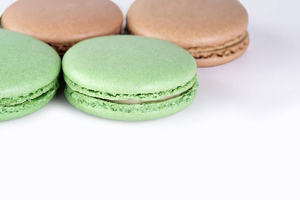 istock Sweet dessert composition: pastel macaron on light background, copy space. 2242376352