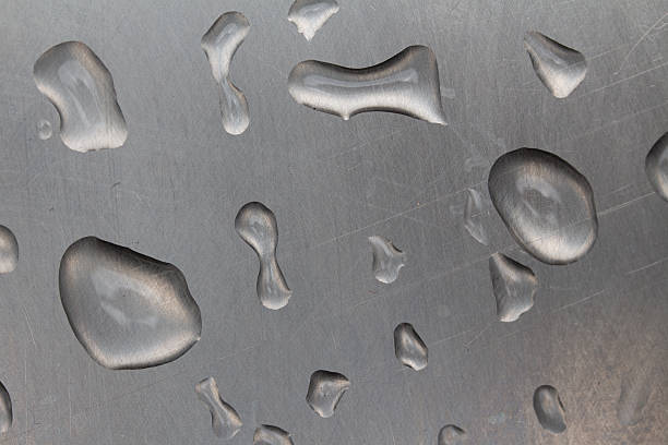 istock Droplets of water resting on a metallic surface in close up view during daytime 2242378352