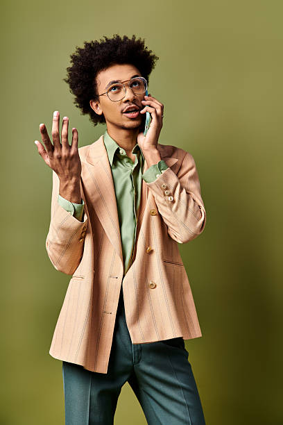 istock Young stylish man expresses emotions while talking on the phone in a trendy setting 2242385823