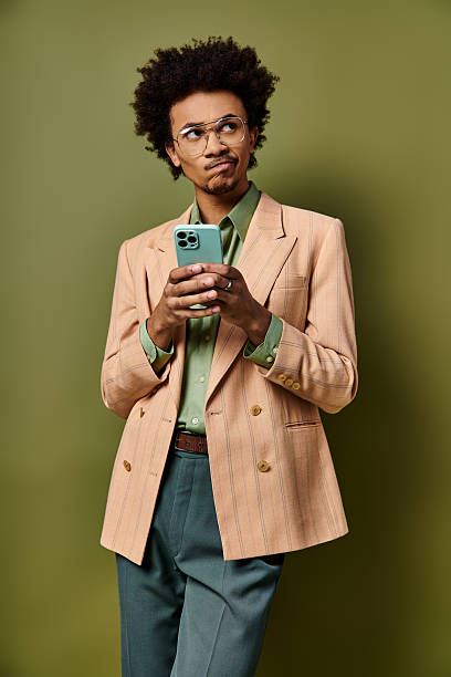 istock Stylish young man expresses emotion while holding his phone in a trendy setting 2242386187