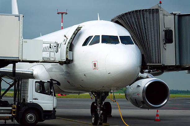 istock Charter airline airplane preparing for flight on airport runway with connected jet boarding bridge 2242386869