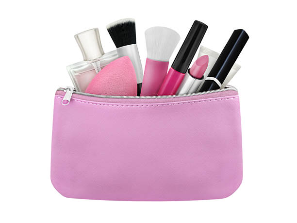 Pink cosmetic bag and make up products isolated on white background