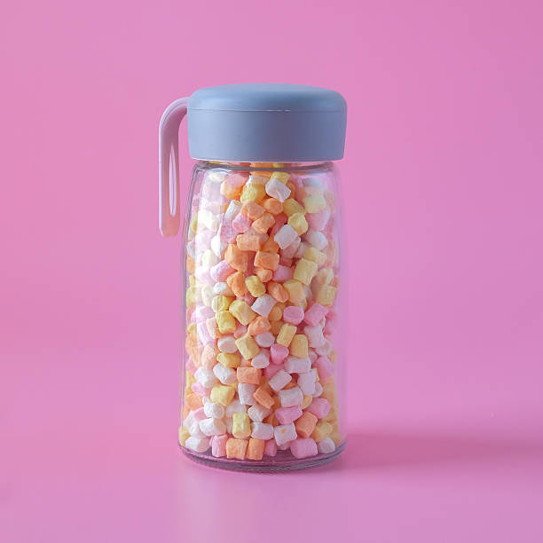 Colorful sweet candy in bottle on background.