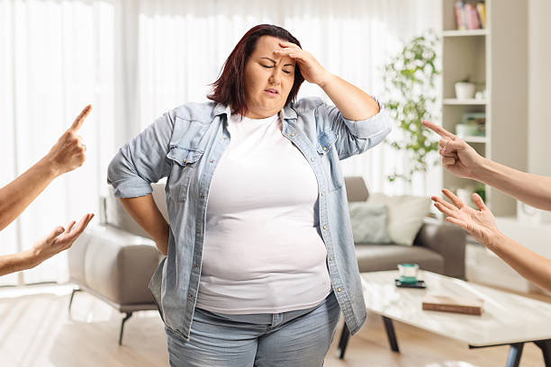 istock People reprimending overweight woman 2242392970