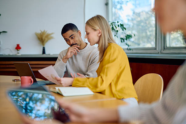 istock Business people collaborating on project in office meeting 2242399027