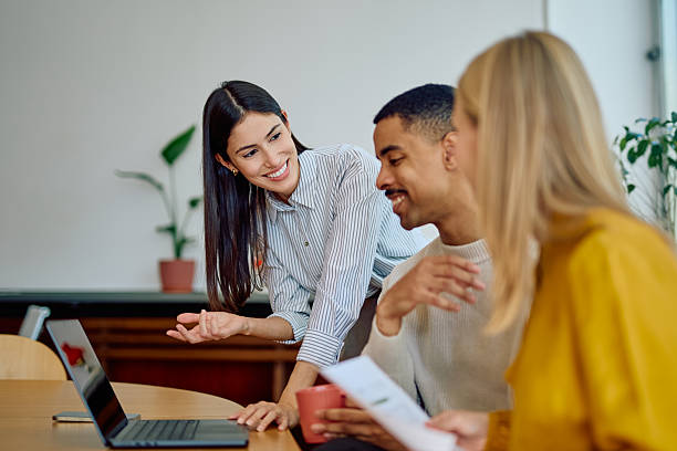 istock Business people collaborating on laptop in office meeting 2242399332