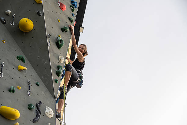 istock Climber Scaling Outdoor Climbing Wall Adventure 2242400066
