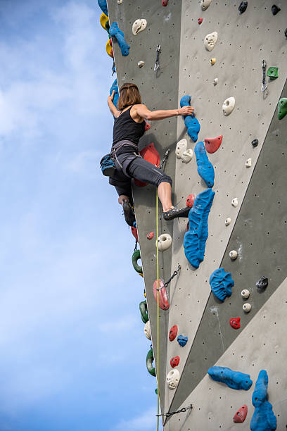 istock Climber On Colorful Outdoor Rock Wall 2242400273