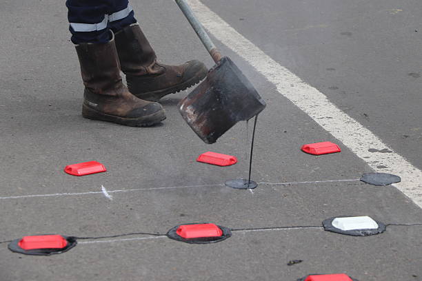 istock Road marking and maintenance work with paint, asphalt and reflective tacks 2242402843