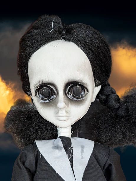 Portrait of cute woman in doll costume holding toy basket over gray background