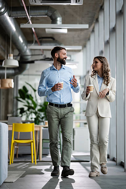 istock Business colleagues walking together discussing during office coffee break 2242405306