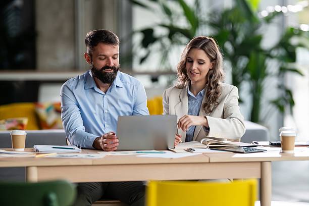 istock Business colleagues collaborating on laptop in office 2242405321