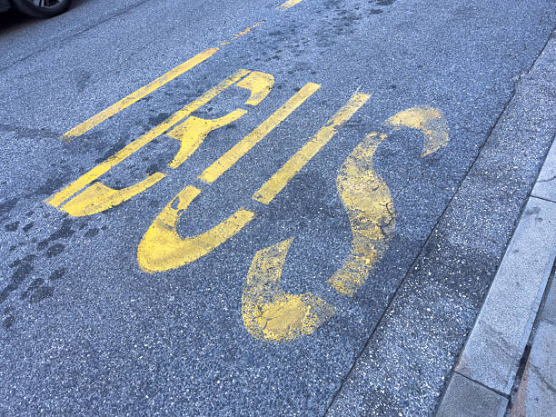 istock Worn yellow bus lane marking on asphalt road surface 2242407108