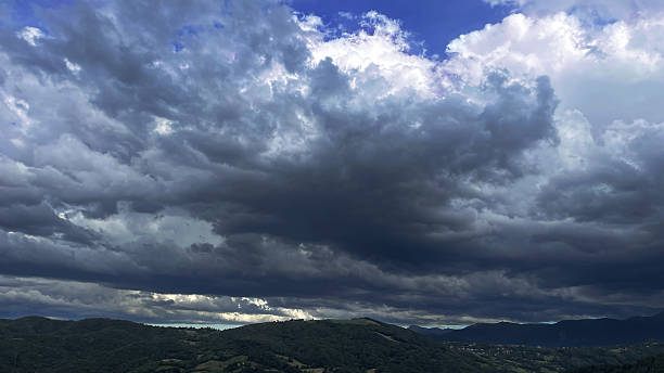 istock Low complex sky with heavy clouds against a backdrop of mountains 2242407561