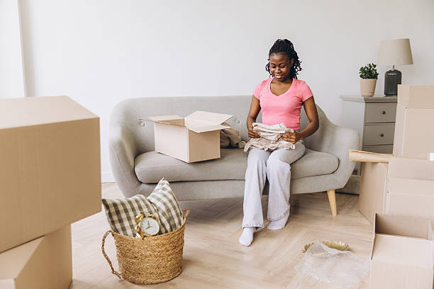 istock African woman unpacking box during moving day 2242408744