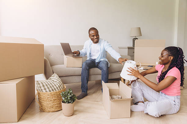 istock African couple unpacking boxes in new house move 2242409286