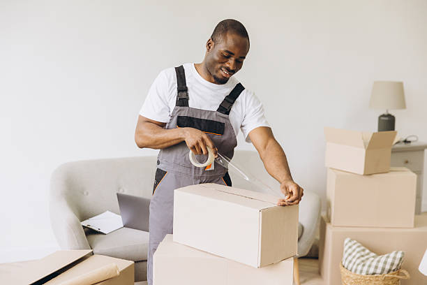 istock Mover man taping cardboard box packing for moving 2242410300