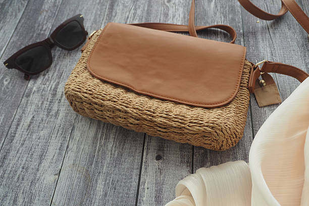 istock Woven bag with sunglasses on wooden surface 2242413794
