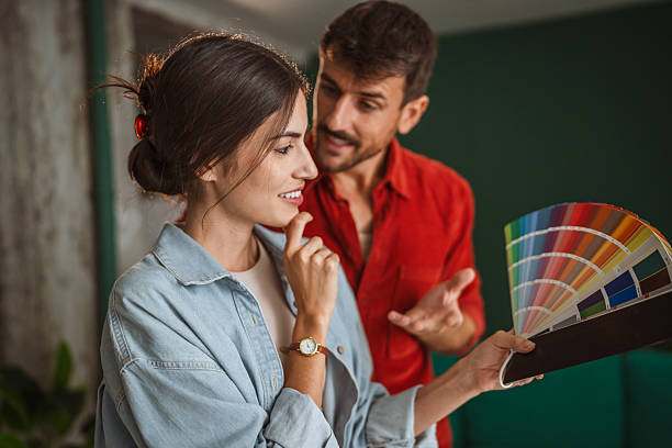 istock Couple choosing paint color for home renovation project 2242413894