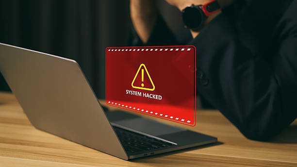 istock Cybersecurity breach alert on a laptop screen showing system hacked warning message, concept of data protection, cyber attack, hacking, computer security risk, and information safety crisis. 2242413921